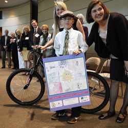 Cougar Gao, 9, from Wasatch Elementary, wins a prize for his age group, from Dr. Stephanie Klein. Gao was one of 27 finalists for the SunWise with SHADE poster contest, sponsored by the U.S. Environmental Protection Agency. Winners were honored Friday, April 6, 2012, at the Huntsman Cancer Institute.