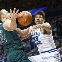Brigham Young forward Yoeli Childs (23) blocks a shot by Utah Valley forward Isaac Neilson (22) during an NCAA college basketball game in Provo on Saturday, Nov. 26, 2016. Utah Valley was 18 of 37 from beyond the arc en route to a 114-101 ousting of Brigham Young.