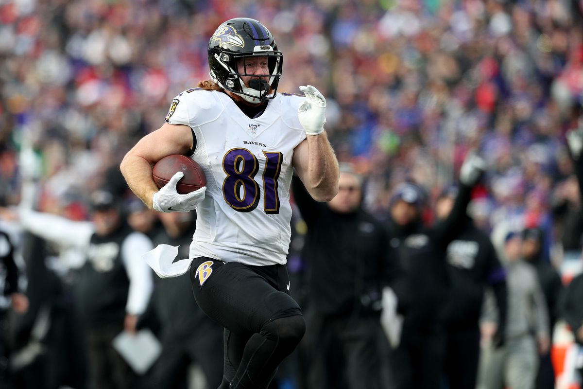 Hayden Hurst #81 of the Baltimore Ravens runs the ball for a touchdown during the third quarter of an NFL game against the Buffalo Bills at New Era Field on December 08, 2019 in Orchard Park, New York.