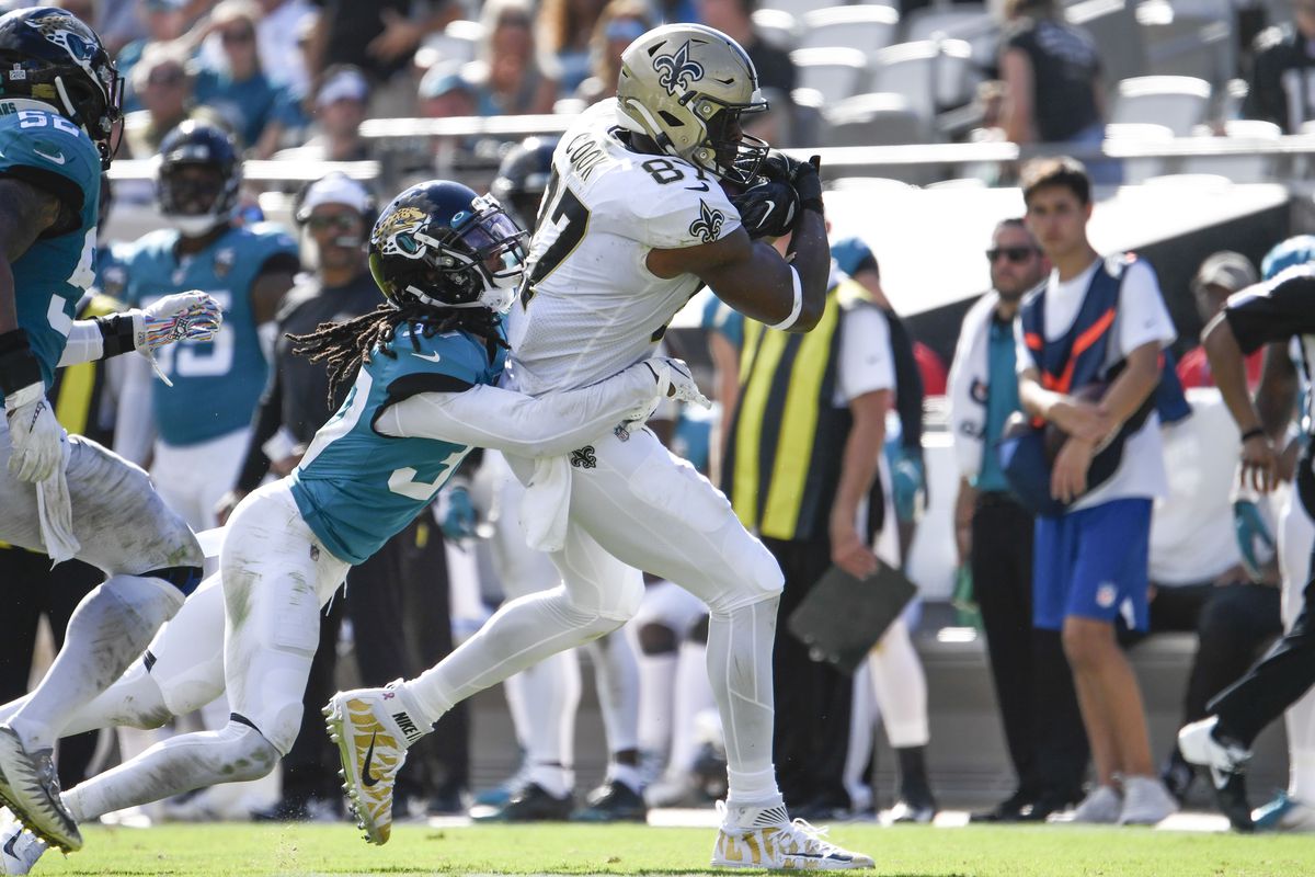 New Orleans Saints tight end Jared Cook runs the ball against Jacksonville Jaguars cornerback Tre Herndon during the fourth quarter at TIAA Bank Field.