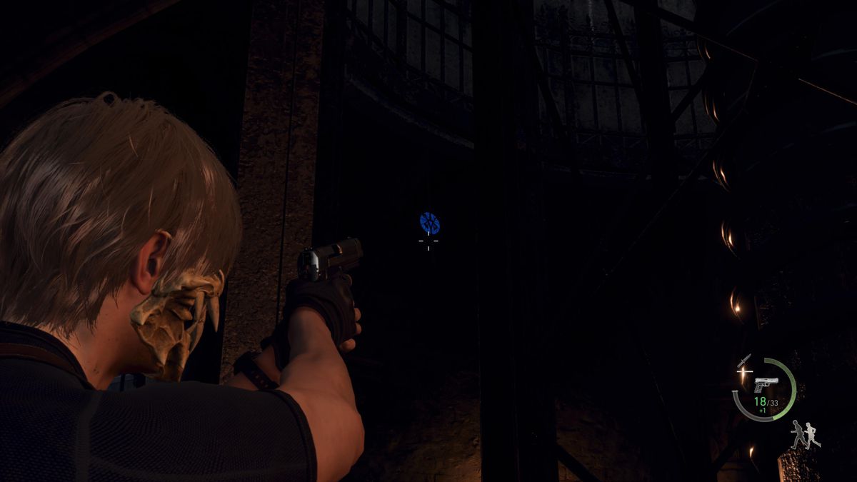 Leon S Kennedy aims at a blue medallion inside the tower with the cannon of the Castle Gate area in Resident Evil 4 remake