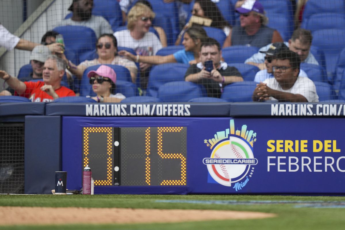 Fans watch from the front row during the game between the Minnesota Twins and Miami Marlins at loanDepot park on April 05, 2023 in Miami, Florida