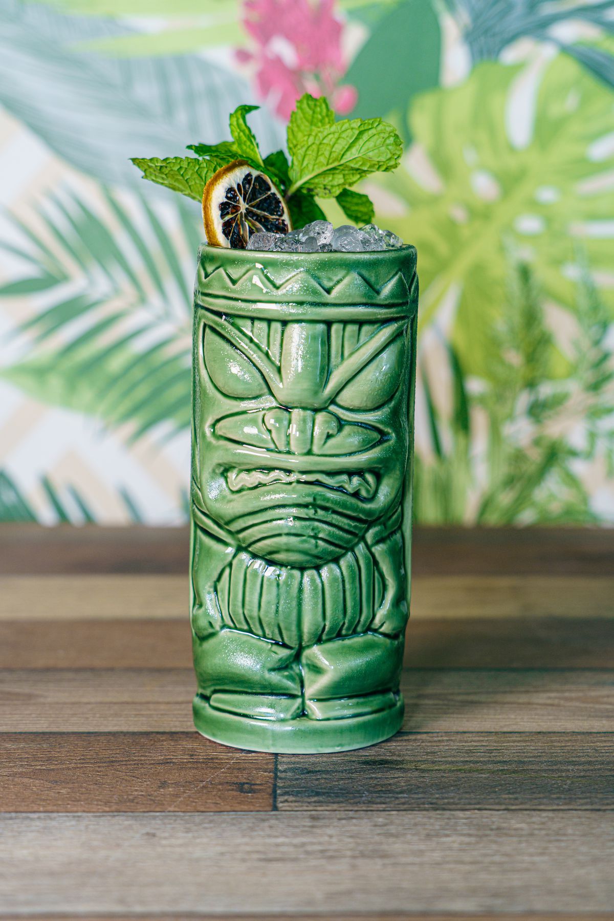 A tiki mug with a tropical cocktail.