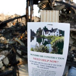 A contractor's advertising is posted on a wood plank Friday in front of a Rancho Bernardo, Calif., home destroyed by fire.