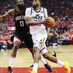 Utah Jazz forward Royce O'Neale (23) drives to the lane on Houston Rockets guard James Harden (13) as the Utah Jazz and the Houston Rockets play game two of the NBA playoffs at the Toyota Center in Houston on Wednesday, May 2, 2018.