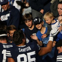 Brigham Young Cougars players greet fans after winning against the UMass Minutemen in a game at LaVell Edwards Stadium in Provo on Saturday, Nov. 19, 2016.