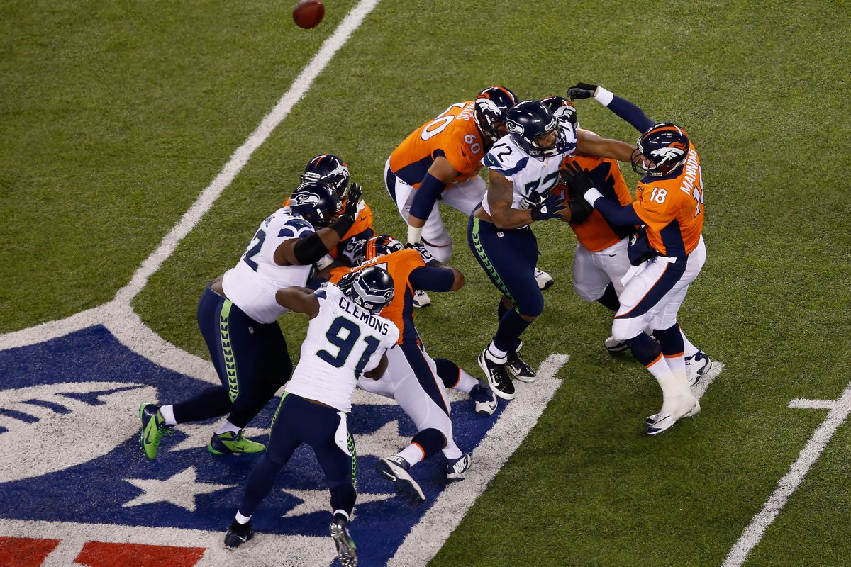Seattle's defensive line getting up close and personal with Peyton Manning...AGAIN.