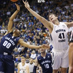 Brigham Young Cougars forward Luke Worthington (41) and San Diego Toreros guard Christopher Anderson (0) compete for the ball in Provo Thursday, Feb. 19, 2015. 