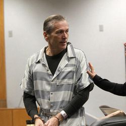 Martin MacNeill, a doctor accused of killing his wife, speaks to his defense attorneys Randy Spencer, left, and Susanne Gustin in Judge Sam McVey's 4th District Court in Provo Wednesday, Oct. 10 during his preliminary hearing.