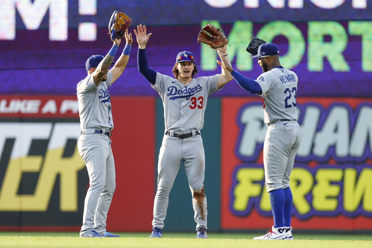 David Peralta, James Outman and Jason Heyward of the Los Angeles Dodgers celebrate a 9-3 win against the Cleveland Guardians at Progressive Field on August 24, 2023 in Cleveland, Ohio.