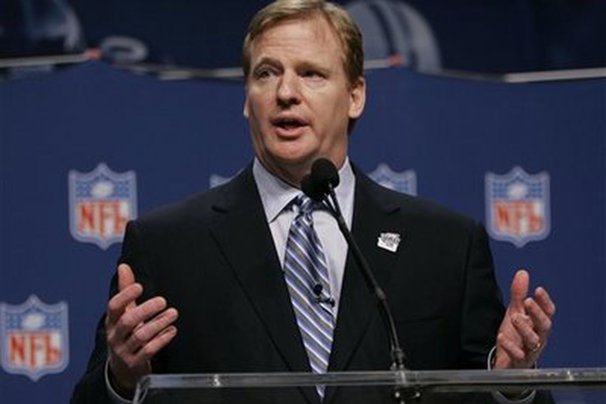 Roger Goodell holding his invisible crystal ball from which he can predict all the draft picks before they're made.