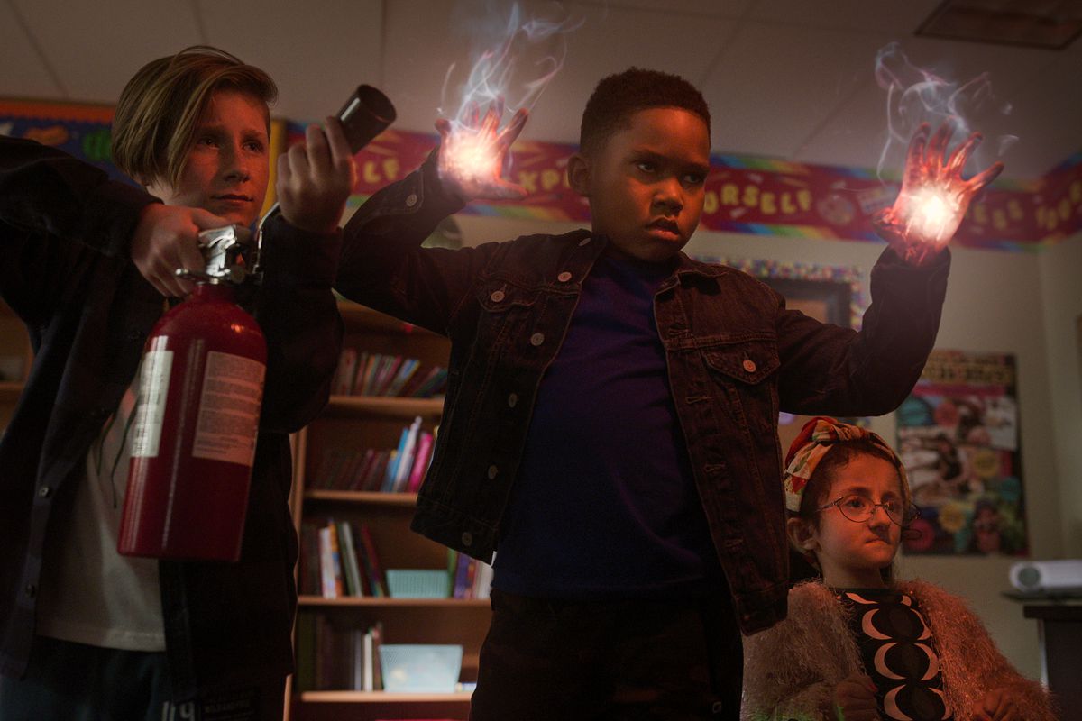 Raising Dion season 2: Dion uses his hand powers while his friend sprays a fire extinguisher
