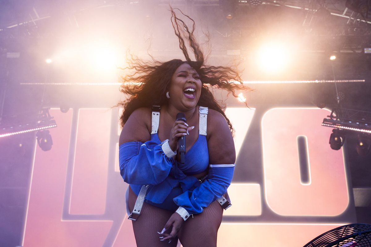 Lizzo onstage singing into a handheld microphone at the FOMO Festival 2020 on January 12 in Melbourne, Australia.