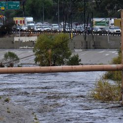Northbound traffic comes to a standstill on Interstate 5 freeway near the rushing water filled Los Angeles river near downtown Los Angeles on Tuesday, Dec. 9, 2018. The first significant storm of the season walloped much of California with damaging winds and thunderstorms. (AP Photo/Richard Vogel)