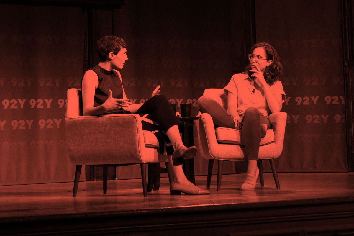 Avery Trufelman and Caity Weaver sitting in chairs and speaking animatedly on the stage of 92Y in New York City