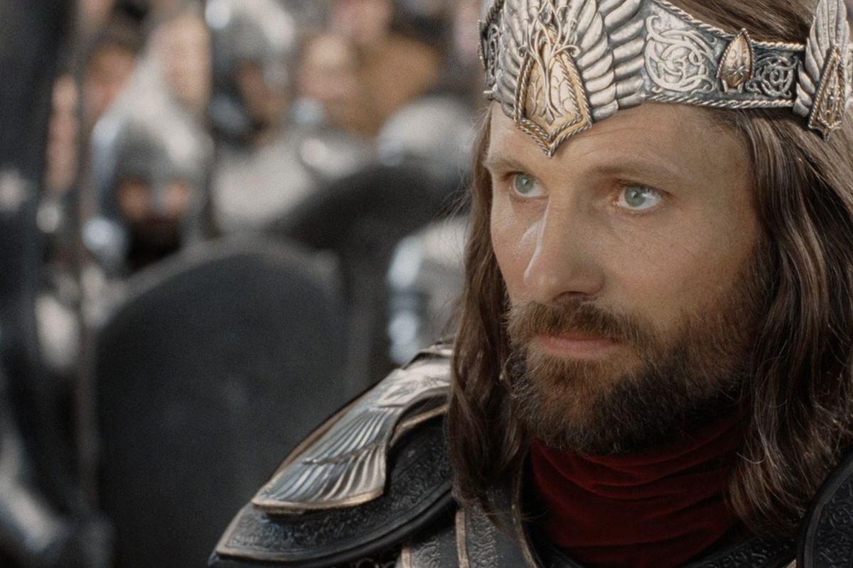 Aragorn from Lord of the Rings looks up, wearing a crown. His hair looks soft and he is well-groomed: it’s his coronation.
