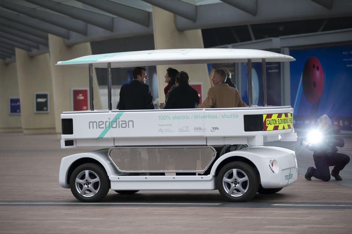 Dignitaries try out a prototype driverless car called a Meridian shuttle during a launch event for the media near the O2 Arena in London, Wednesday, Feb. 11, 2015. 