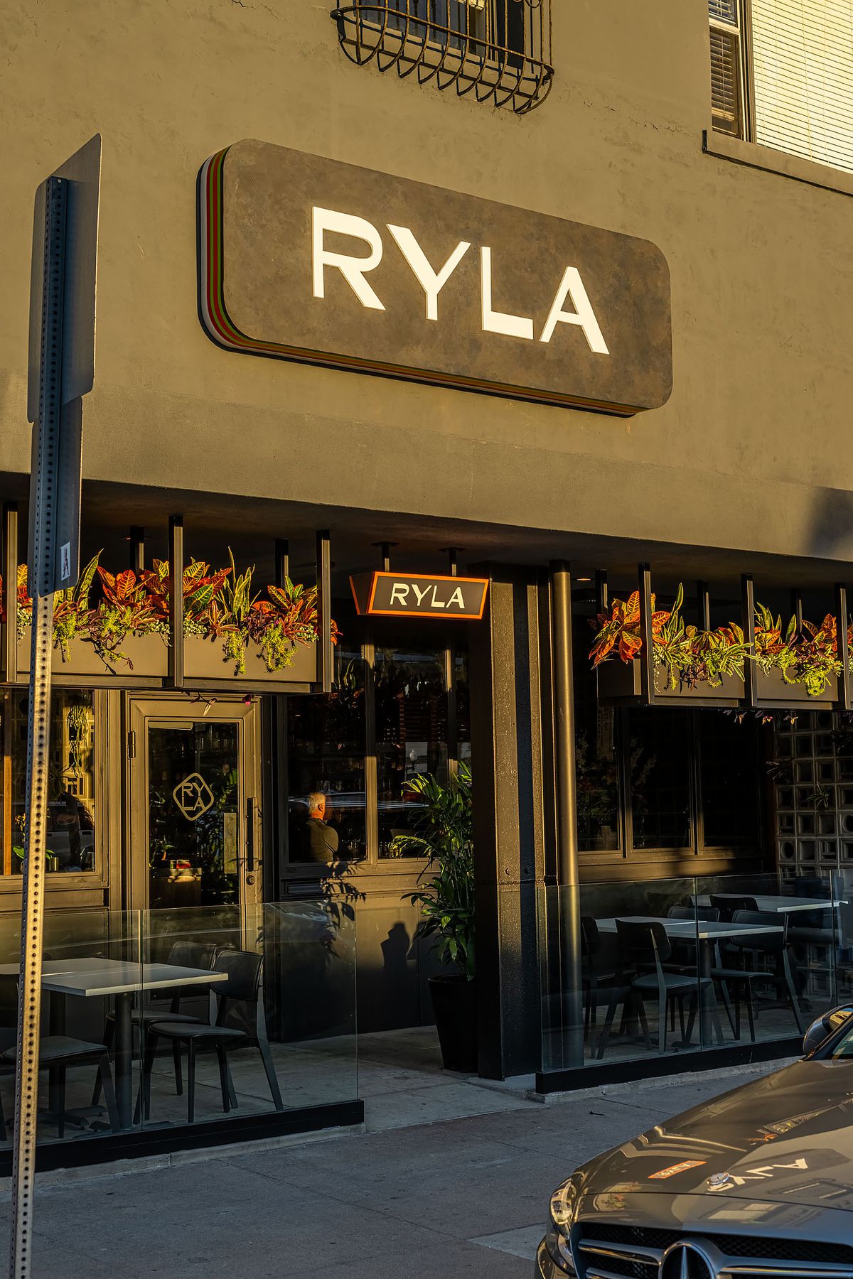 Outside Ryla storefront with patio seats.