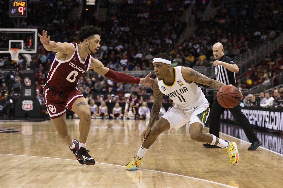 Baylor Bears guard James Akinjo (11) handles the ball while defended by Oklahoma Sooners guard Jordan Goldwire (0) in the second half at T-Mobile Center.&nbsp;