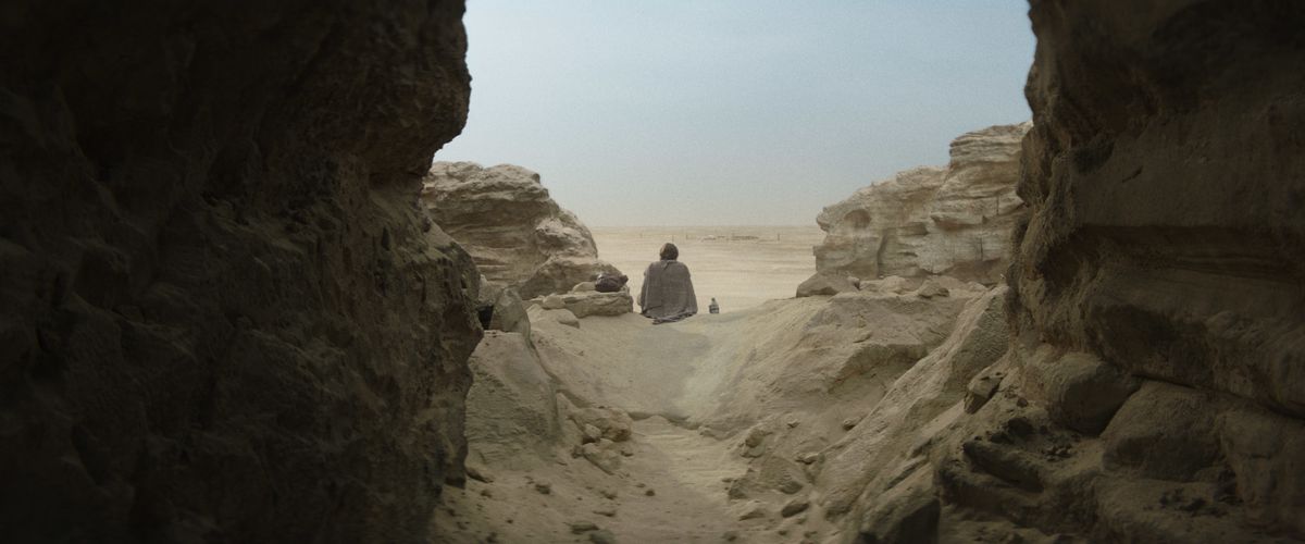 Obi-Wan sitting in the dirt looking out at the desert