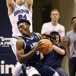 Loyola Marymount Lions guard James Batemon (5) has his progress altered by Brigham Young Cougars guard McKay Cannon (24) as the Brigham Young Cougars take on the Loyola Marymount Lions at the Marriott Center in Provo on Thursday, Jan. 18, 2018.