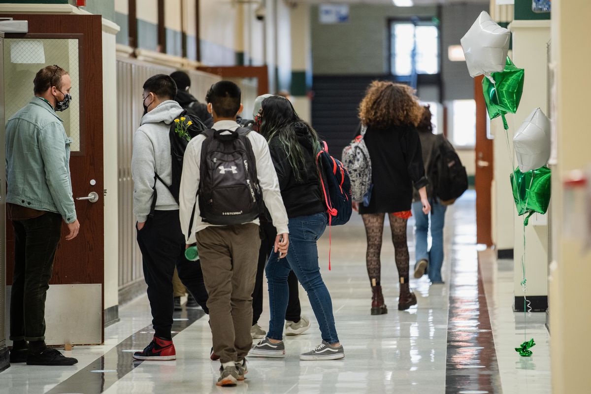 Students walk down the hall at Nicholas Senn High School in Edgewater on April 23, 2021.