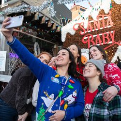 A group poses for a selfie outside the Santa Baby bar on Clark Street Saturday in Wrigleyville.