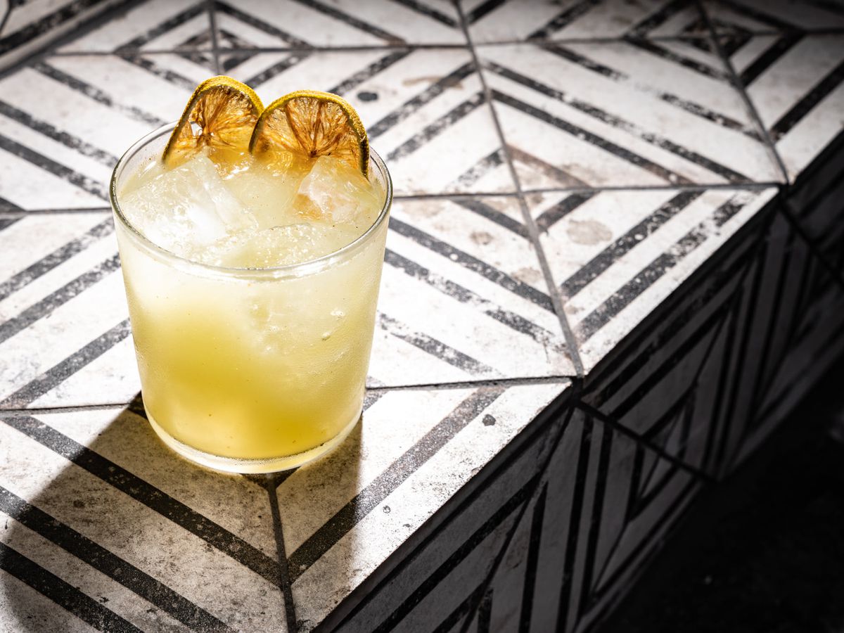 A tequila cocktail garnished with dried citrus.