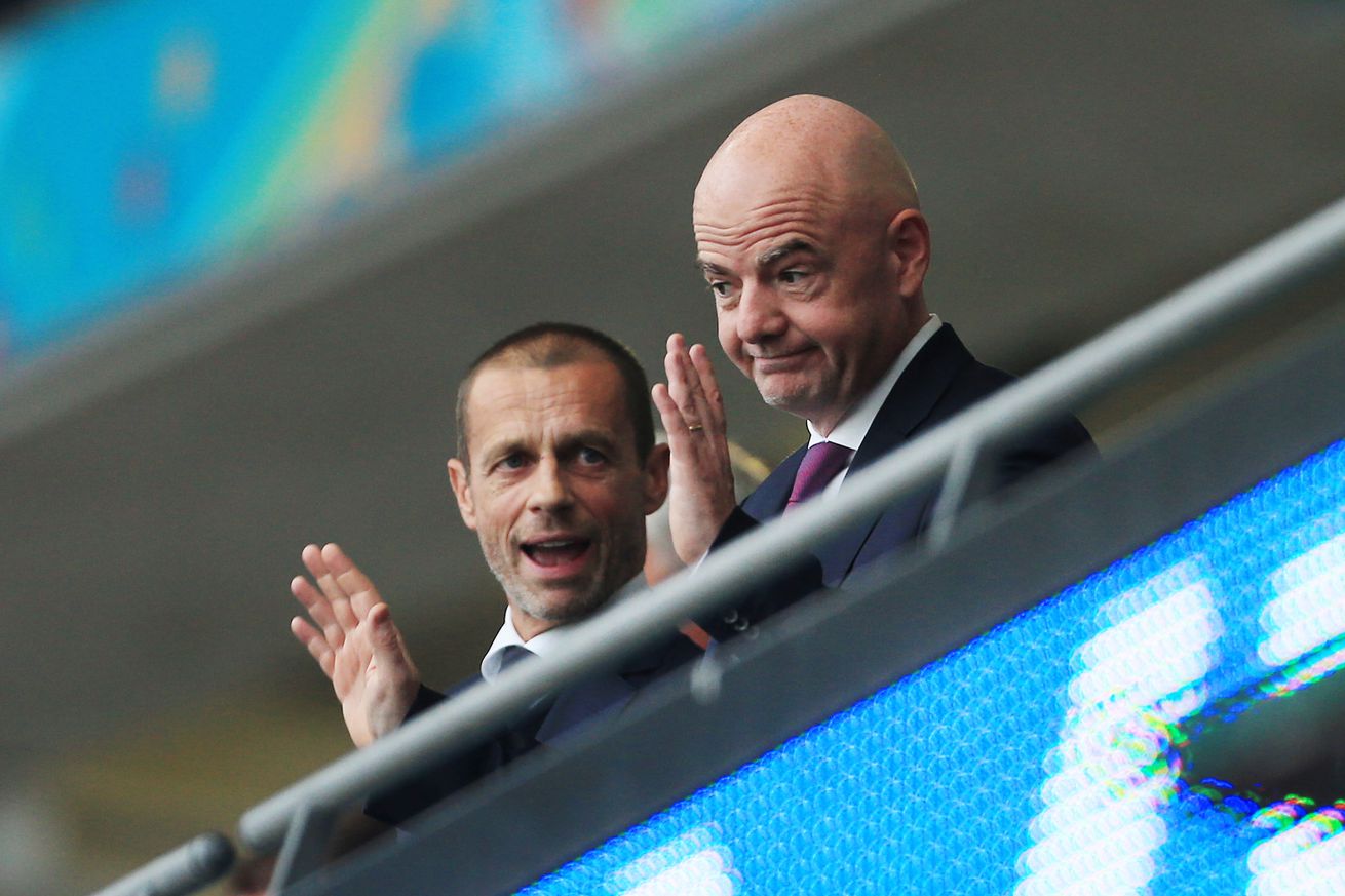 UEFA President Aleksander Ceferin (L) talks to FIFA President Gianni Infantino during the UEFA Euro 2020 Championship Final between Italy and England at Wembley Stadium on July 11, 2021