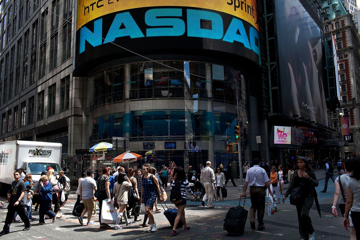 The entrance to the Nasdaq building with pedestrians walking by