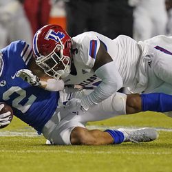 Louisiana Tech linebacker Trey Baldwin, right, tackles BYU wide receiver Neil Pau’u (2) during the second half of an NCAA college football game Friday, Oct. 2, 2020, in Provo. 
