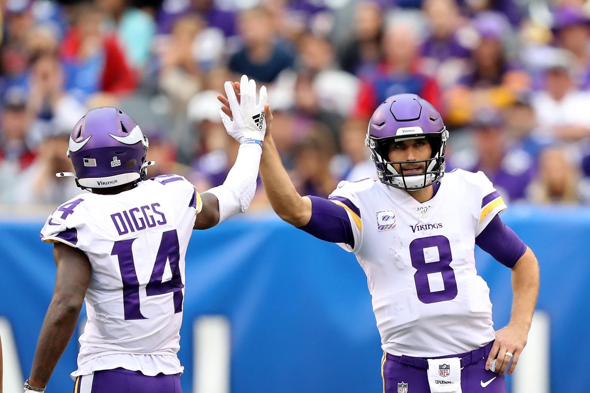 Kirk Cousins of the Minnesota Vikings congratulates Stefon Diggs after a catch in the fourth quarter against the New York Giants at MetLife Stadium on October 06, 2019 in East Rutherford, New Jersey.