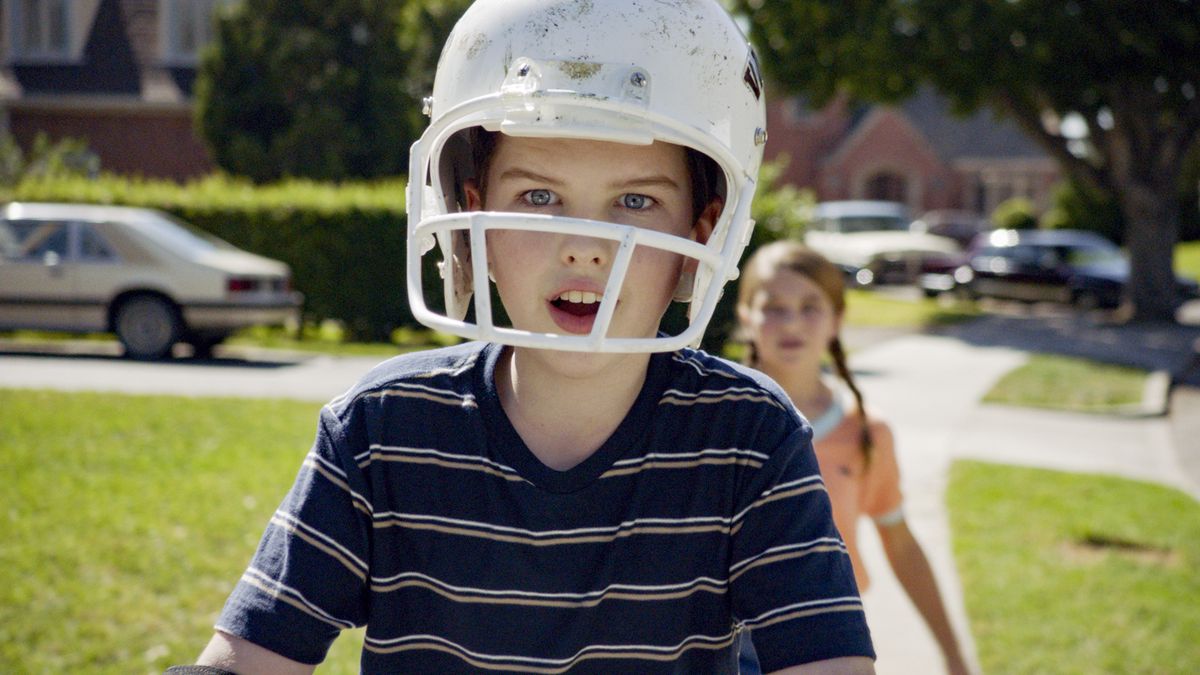 Iain Armitage in a football helmet with his mouth hanging open in Young Sheldon