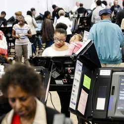 Early voters use electronic ballot casting machines at the Franklin County Board of Elections, Monday, Nov. 7, 2016, in Columbus, Ohio. Heavy turnout has caused long lines as voters take advantage of their last opportunity to vote before election day. 
