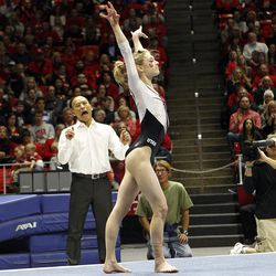 Utah Red Rocks co-head coach Tom Farden, left, cheers on gymnast MaKenna Merrell during an NCAA gymnastics meet versus the Brigham Young Cougars at the Jon M. Huntsman Center in Salt Lake City, Friday, Jan. 8, 2016.