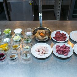 <b>The Ingredients</b> 
On the left in glass bowls, left to right from top row: sea salt, celery, whole milk, pink salt, egg white, dextrose, green onion, thyme, onion, eggs, brandy, garlic, black pepper, red wine, nutmeg, and bay leaf.
On the right, on