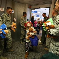 Danika Blamires walks into the jetway as she joins American Airline's 11th annual Snowball Express on at the Salt Lake City International Airport Sunday, Dec. 11, 2016, an event for children of fallen military heroes. Ten chartered American aircraft departed numerous cities — including Salt Lake City — to pick up nearly 1,800 children and spouses for an all-expense-paid journey to Dallas-Fort Worth area. While there, the families will participate in a series of activities starting with a Texas-sized welcome, a tour of the Fort Worth Museum of Science and History, a night of jousting fun at Medieval Times and a private concert by Academy Award-nominated actor Gary Sinise and the Lt. Dan Band.
