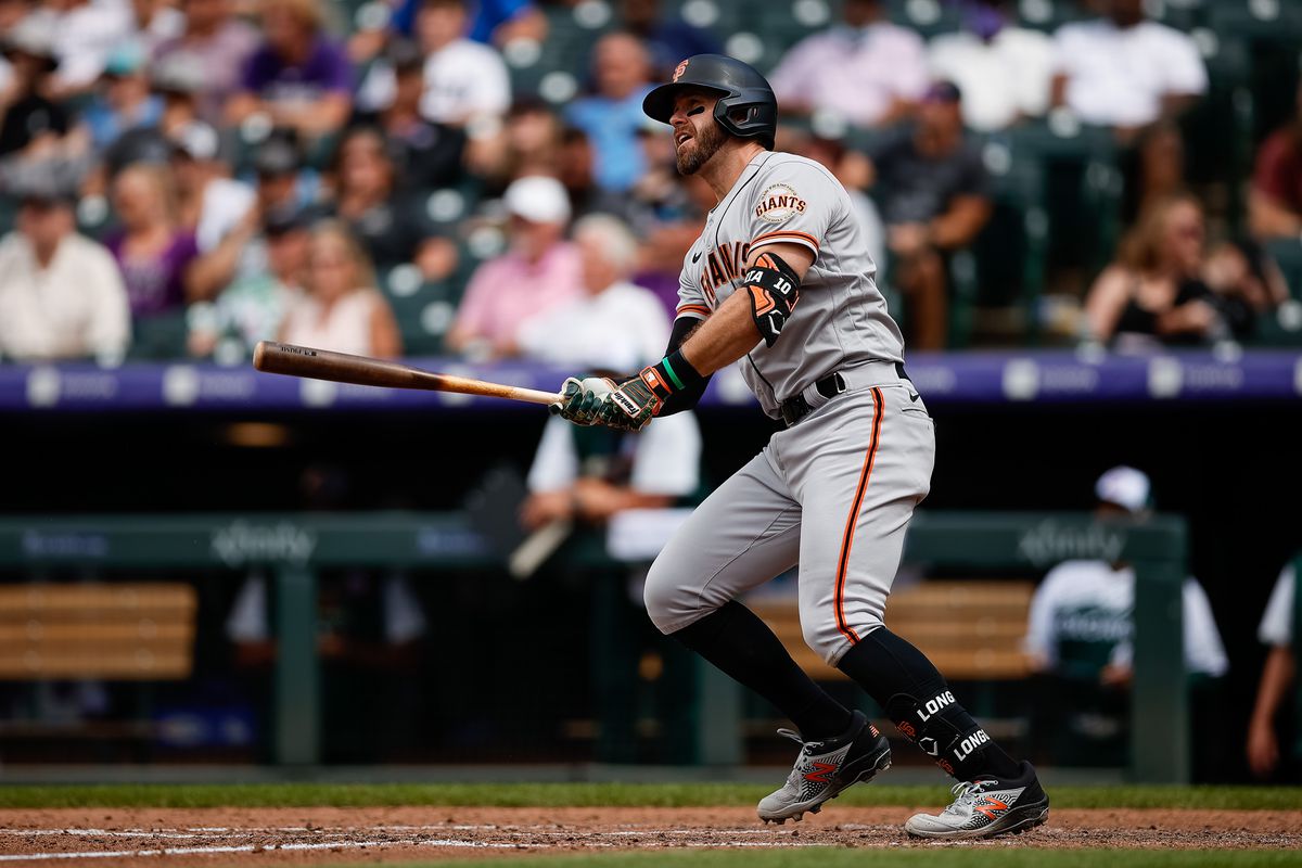 MLB: San Francisco Giants third baseman Evan Longoria swings watches his grand slam to left sail out of the park in Colorado