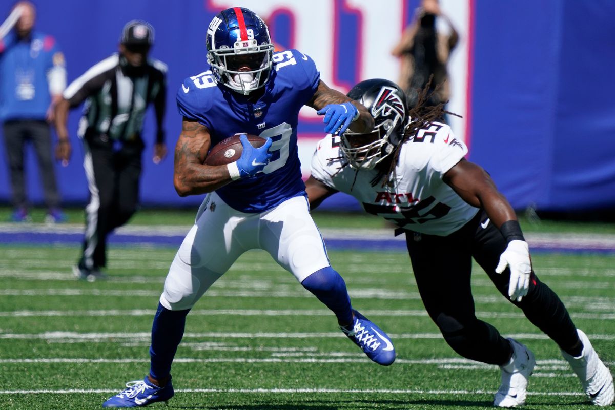 New York Giants wide receiver Kenny Golladay (19) runs with the ball as Atlanta Falcons linebacker Steven Means (55) defends at MetLife Stadium.&nbsp;