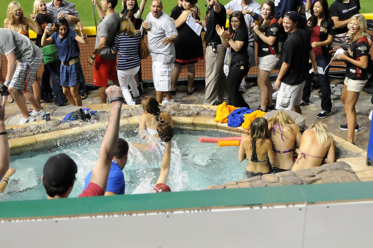 PHOENIX, AZ - JULY 11:  A fan catches a home run ball in the pool during the 2011 State Farm Home Run Derby at Chase Field on July 11, 2011 in Phoenix, Arizona.  (Photo by Norm Hall/Getty Images)