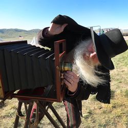 Vintage photographer Mark Brown takes a photo during the 150th anniversary celebration at the Golden Spike National Historical Park at Promontory Summit on Friday, May 10, 2019.