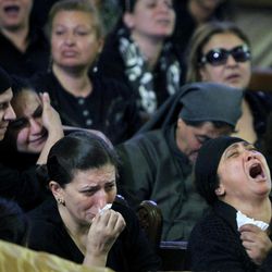 Egyptian Christians grieve during a funeral service at the Saint Mark Coptic cathedral in Cairo, Egypt, Sunday, April 7, 2013. Several Egyptians including 4 Christians and a Muslim were killed in sectarian clashes before dawn in Qalubiya, just outside of Cairo on Saturday, April 6, 2013. 