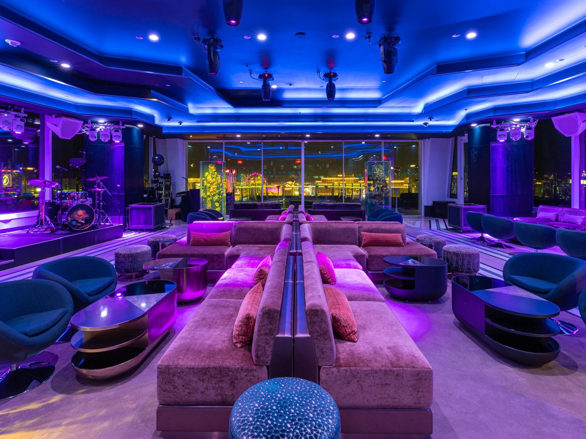 A swanky lounge illuminated with blue and purple lighting