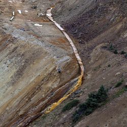 Wastewater flows from a trough and down a steep ravine Thursday, Aug. 13, 2015, at the site of the blowout at the Gold King mine. The blowout triggered a major spill of toxic wastewater outside Silverton, Colo.