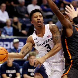 Brigham Young Cougars guard Te’Jon Lucas (3) passes around Pacific Tigers guard Jalen Brown (2) as BYU and Pacific play in an NCAA basketball game in Provo at the Marriott Center on Thursday, Jan. 6, 2022. BYU won 73-51.
