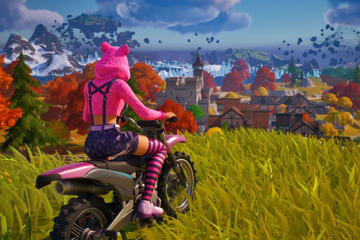 A Fortnite character in a pink fuzzy bear hoodie overlooks a town while atop a motorcycle