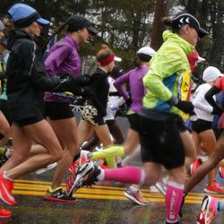Sarah Sellers, of the United States, center in purple with black cap, sets out from the start in the middle of the elite womens pack during the 122nd running of the Boston Marathon in Hopkinton, Mass., Monday, April 16, 2018. Sellers finished second. (AP Photo/Mary Schwalm)