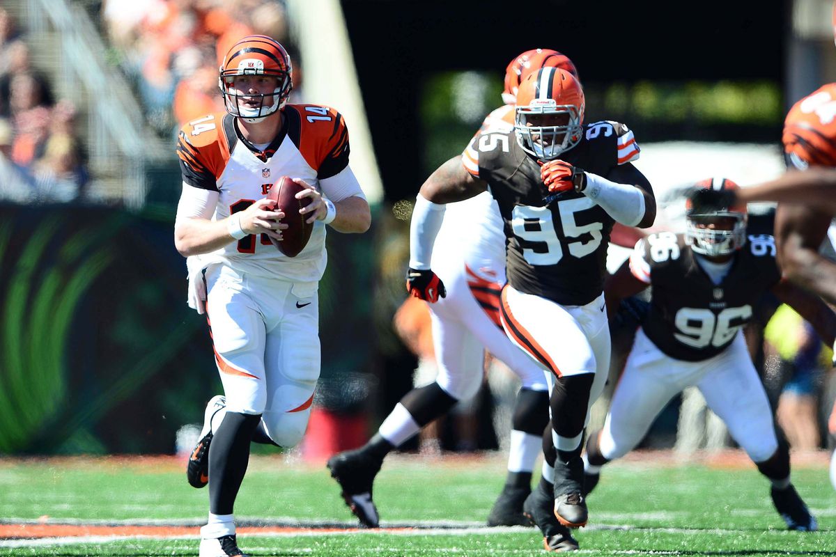 Sep 16, 2012; Cincinnati, OH, USA; Cincinnati Bengals quarterback Andy Dalton (14) scrambles out of the pocket in the second quarter against the Cleveland Browns at Paul Brown Stadium. Mandatory Credit: Andrew Weber-US Presswire