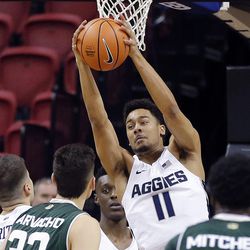 Utah State Aggies forward Alex Dargenton pulls in a rebound against the Colorado State Rams during the Mountain West Conference basketball tournament in Las Vegas on Wednesday, March 7, 2018.