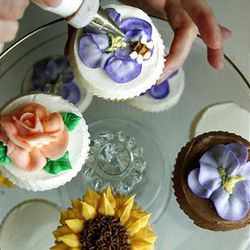 Cupcake maker Elizabeth Plehn's decorating specialty is flowers. Depending on the level of detail, one cupcake can take several minutes to decorate.